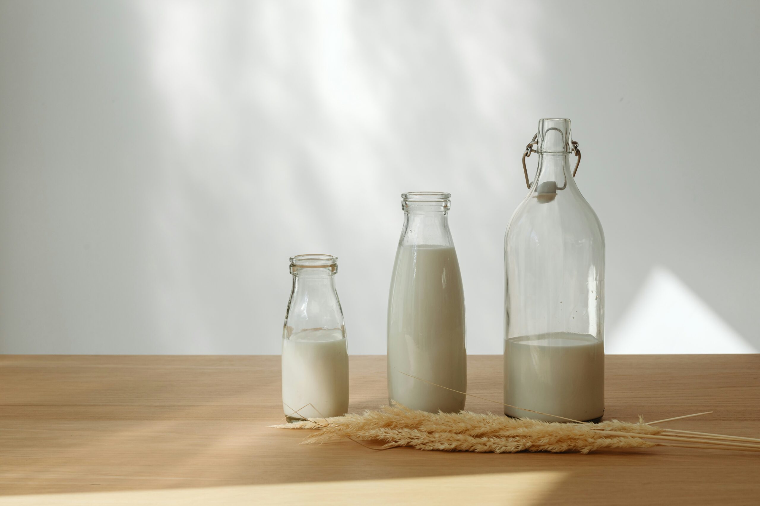 Shelves stocked with various plant-based milk brands